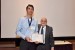 Dr. Nagib Callaos, General Chair, giving Kevin Fox an award certificate in appreciation for his presentation oriented to inter-disciplinary communication entitled: "Systematically Managing Organizational Change."